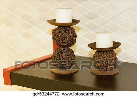 Candlestick holder with candles on a table View Large Photo Image Stock Image - Candlestick holder with candles on a table. Fotosearch