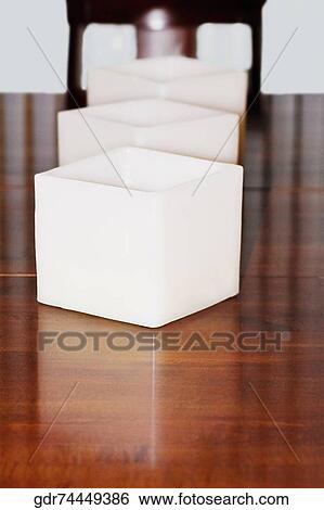 Stock Photograph - Candlestick holders on a dining table. Fotosearch