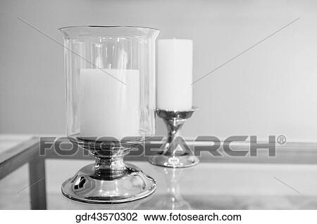 Stock Image - Candlestick holders on a table. Fotosearch