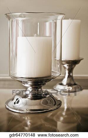 Stock Photo - Candlestick holders on a table. Fotosearch