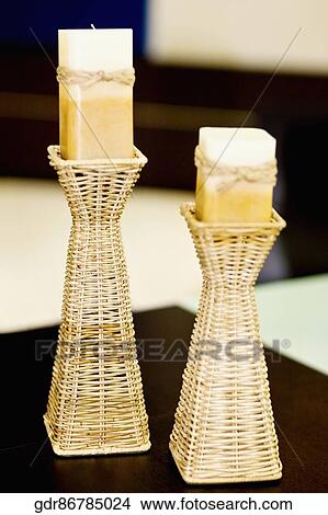 Candlestick holders with candles on a table View Large Photo Image Picture - Candlestick holders with candles on a table. Fotosearch
