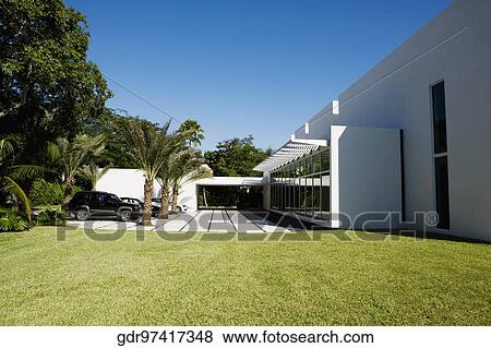 Stock Photo - Cars parked in the driveway of a house. Fotosearch