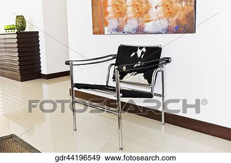 Chair with a painting in a room View Large Photo Image Stock Photo - Chair with a painting in a room. Fotosearch