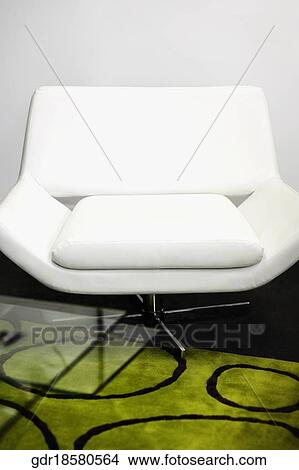 Chair with a table in a living room View Large Photo Image Picture - Chair with a table in a living room. Fotosearch