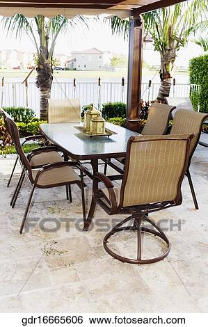 Chairs around a dining table View Large Photo Image Stock Photograph - Chairs around a dining table. Fotosearch
