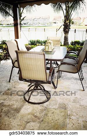 Chairs around a dining table View Large Photo Image Stock Photography - Chairs around a dining table. Fotosearch
