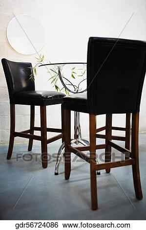 Chairs in a dining room View Large Photo Image Stock Photograph - Chairs in a dining room. Fotosearch