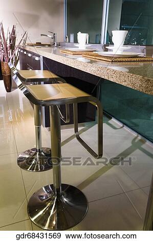 Chairs near a kitchen counter View Large Photo Image Stock Photo - Chairs near a kitchen counter. Fotosearch