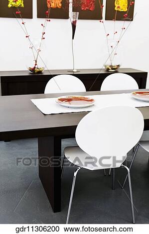 Chairs with a table in a dining room View Large Photo Image Stock Image - Chairs with a table in a dining room. Fotosearch