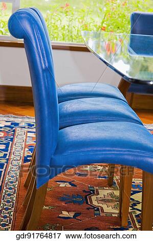 Chairs with a table in a dining room View Large Photo Image Stock Photo - Chairs with a table in a dining room. Fotosearch