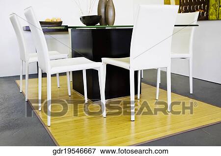 Chairs with a table in a living room View Large Photo Image Stock Photo - Chairs with a table in a living room. Fotosearch