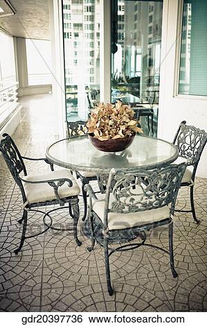 Stock Photograph - Chairs with a table in a living room. Fotosearch