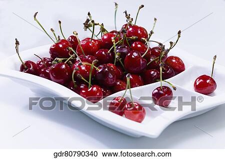 Stock Image - Cherries in a tray on a table. Fotosearch