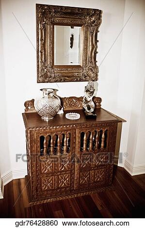 Stock Image - Chest and mirror in a living room. Fotosearch