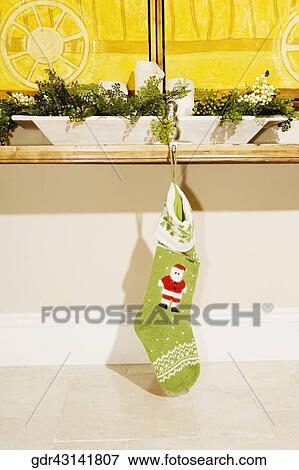 Christmas stockings hanging with a table View Large Photo Image Stock Photo - Christmas stockings hanging with a table. Fotosearch