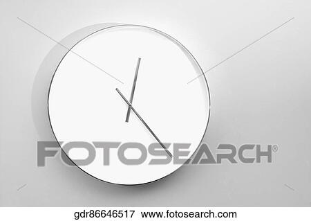 Stock Photo - Close-up of a clock hanging on the wall. Fotosearch