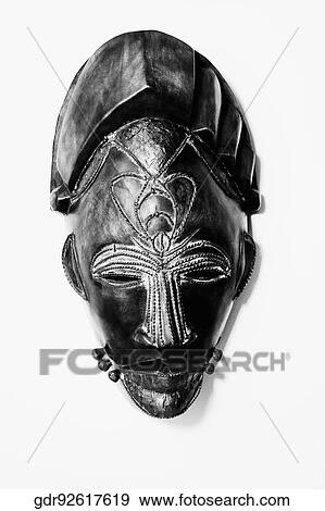 Close-up of a mask mounted on a wall View Large Photo Image Stock Photo - Close-up of a mask mounted on a wall. Fotosearch