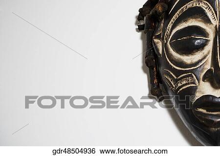 Close-up of a mask mounted on a wall View Large Photo Image Stock Photograph - Close-up of a mask mounted on a wall. Fotosearch