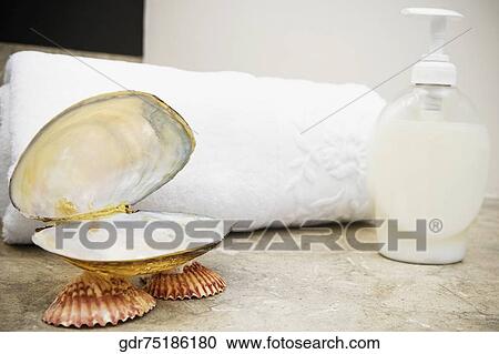 Close-up of a soap dish with a soap dispenser and a towel View Large Photo Image Stock Image - Close-up of a soap dish with a soap dispenser and a towel. Fotosearch