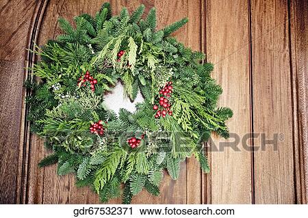 Close-up of a wreath hanging on a door View Large Photo Image Stock Image - Close-up of a wreath hanging on a door. Fotosearch