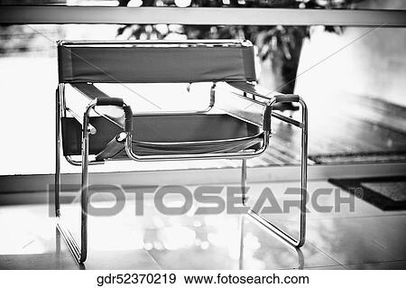 Close-up of an armchair in a living room View Large Photo Image Stock Photo - Close-up of an armchair in a living room. Fotosearch