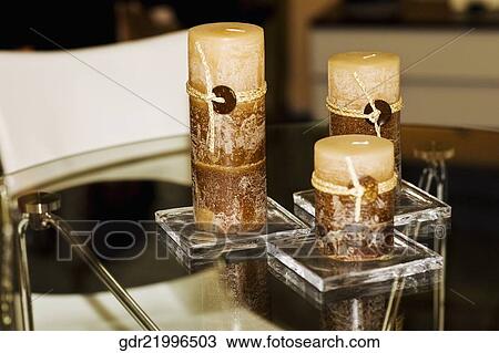 Close-up of candles on a dining table View Large Photo Image Stock Image - Close-up of candles on a dining table. Fotosearch