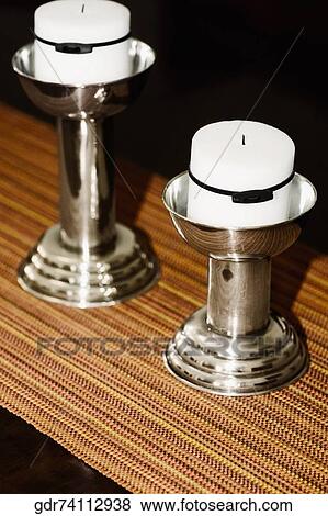Close-up of candlestick holders on a table View Large Photo Image Stock Photo - Close-up of candlestick holders on a table. Fotosearch