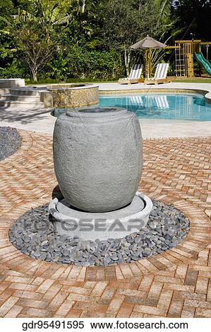 Close-up of decorative urn with a swimming pool in the background View Large Photo Image Stock Photography - Close-up of decorative urn with a swimming pool in the background. Fotosearch