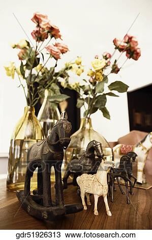 Stock Image - Close-up of figurines with flower vases. Fotosearch