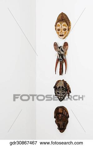 Close-up of masks mounted on a wall View Large Photo Image Stock Photo - Close-up of masks mounted on a wall. Fotosearch