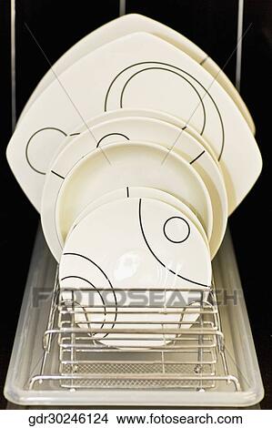Close-up of plates and trays in a rack View Large Photo Image Picture - Close-up of plates and trays in a rack. Fotosearch