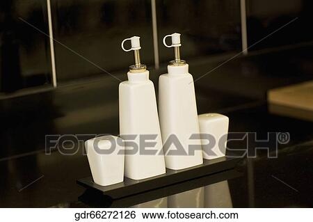 Close-up of salt shaker and pepper shaker with bottles View Large Photo Image Stock Photograph - Close-up of salt shaker and pepper shaker with bottles. Fotosearch