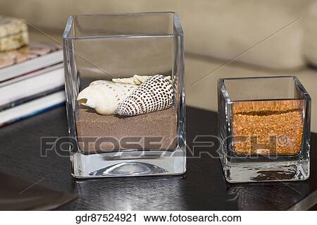 Close-up of showpieces and books on a table View Large Photo Image Stock Image - Close-up of showpieces and books on a table. Fotosearch