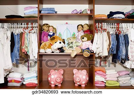 Stock Image - Clothes and toys in a wardrobe. Fotosearch