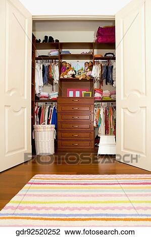 Clothes and toys in a wardrobe View Large Photo Image Stock Image - Clothes and toys in a wardrobe. Fotosearch