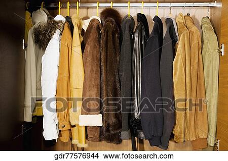 Clothes hanging in an almirah View Large Photo Image Picture - Clothes hanging in an almirah. Fotosearch