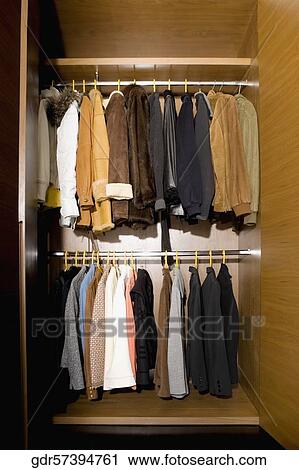 Clothes hanging in an almirah View Large Photo Image Stock Image - Clothes hanging in an almirah. Fotosearch
