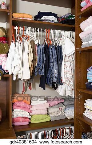 Clothes in a closet View Large Photo Image Picture - Clothes in a closet. Fotosearch