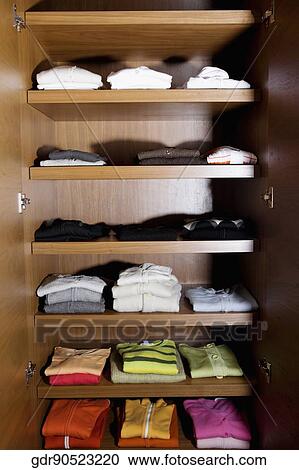 Clothes on shelves View Large Photo Image Stock Image - Clothes on shelves. Fotosearch
