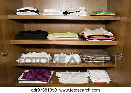 Clothes on shelves View Large Photo Image Stock Image - Clothes on shelves. Fotosearch