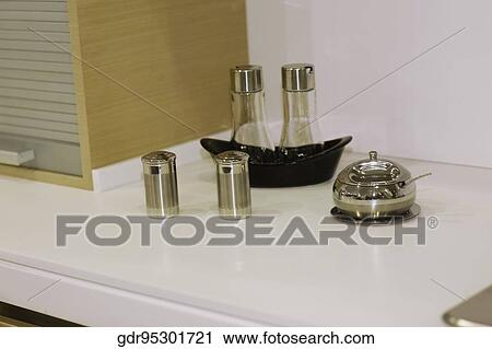 Container with salt shaker and pepper shaker on a kitchen counter View Large Photo Image Stock Image - Container with salt shaker and pepper shaker on a kitchen counter. Fotosearch