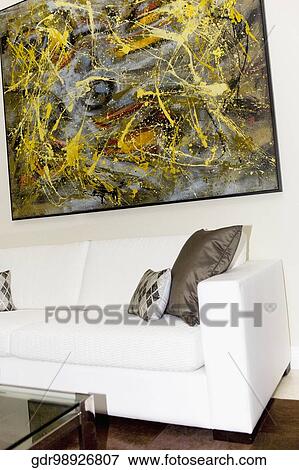Couch and paintings in a living room View Large Photo Image Stock Photo - Couch and paintings in a living room. Fotosearch