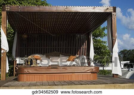Couch in a poolside cabana View Large Photo Image Stock Photo - Couch in a poolside cabana. Fotosearch