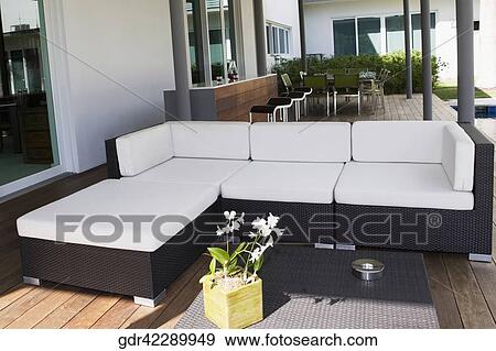 Stock Photo - Couch under a patio. Fotosearch