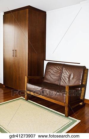 Couch with a wardrobe in a living room View Large Photo Image Stock Photo - Couch with a wardrobe in a living room. Fotosearch