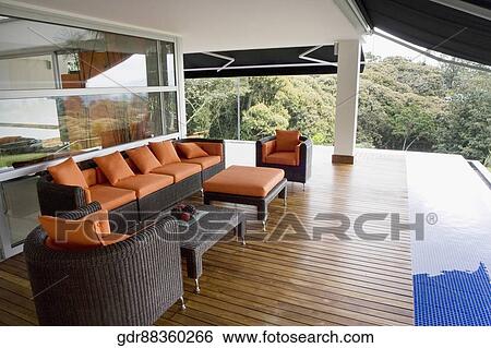 Stock Photograph - Couches and tables in a porch. Fotosearch