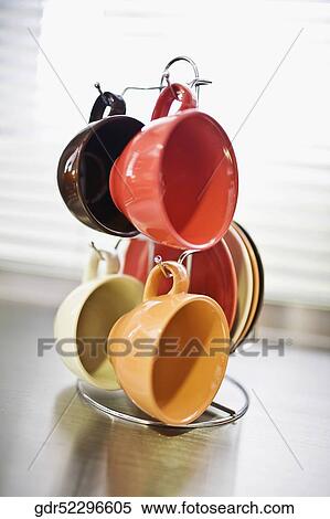 Cups hanging on a stand View Large Photo Image Stock Photography - Cups hanging on a stand. Fotosearch