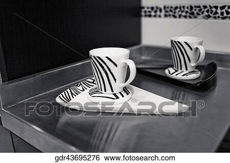 Cups with trays on a kitchen counter View Large Photo Image Stock Photograph - Cups with trays on a kitchen counter. Fotosearch