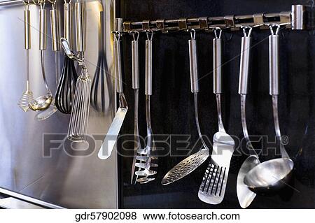 Cutlery hanging in the kitchen View Large Photo Image Stock Photo - Cutlery hanging in the kitchen. Fotosearch