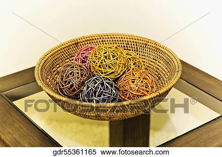 Decorative balls in a wicker basket on a table View Large Photo Image Stock Photography - Decorative balls in a wicker basket on a table. Fotosearch